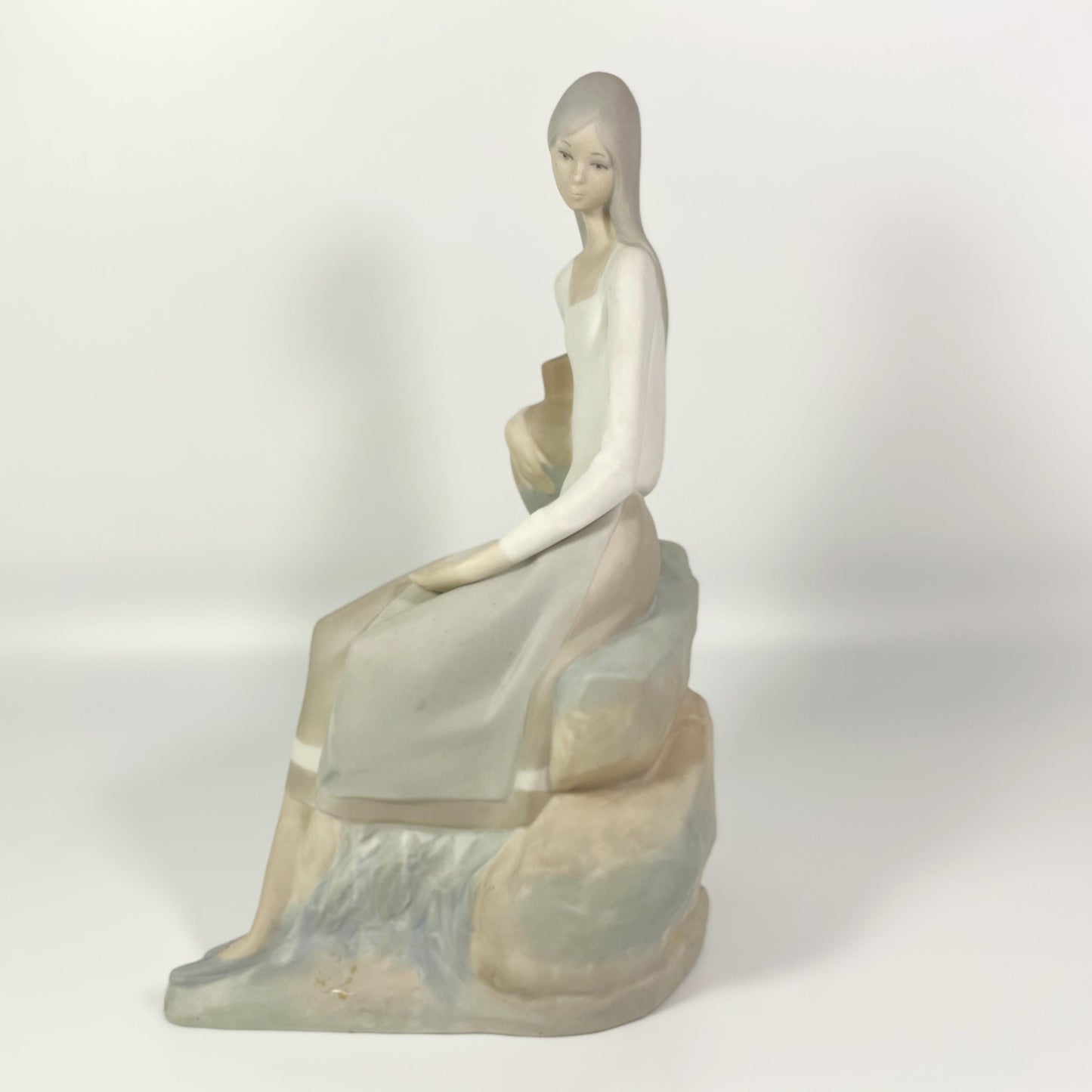 Nao by Lladro " girl sitting on rocks with jug " 9.5” tall porcelain figurine - Vtg