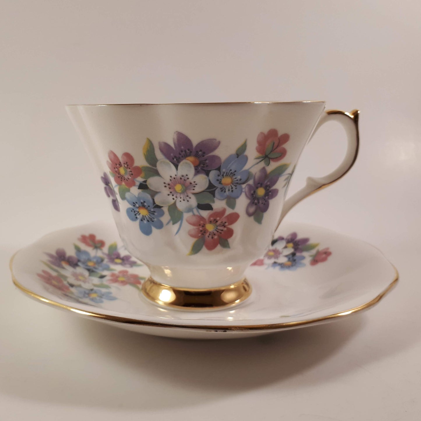 Gorgeous Queen Anne multicolored floral bone china teacup and saucer