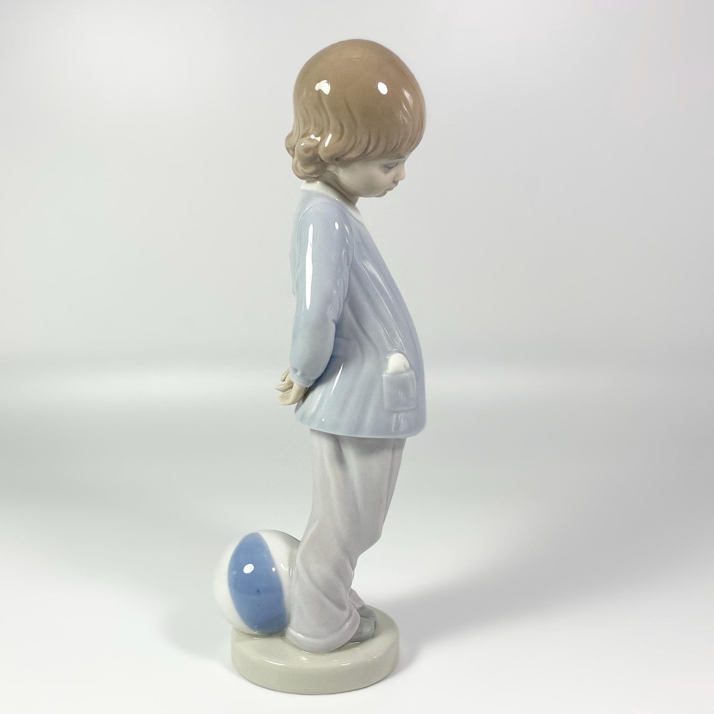 Lladro Porcelain Figurine: Boy w/beach ball #4899 "Punishment" - retired in 1983