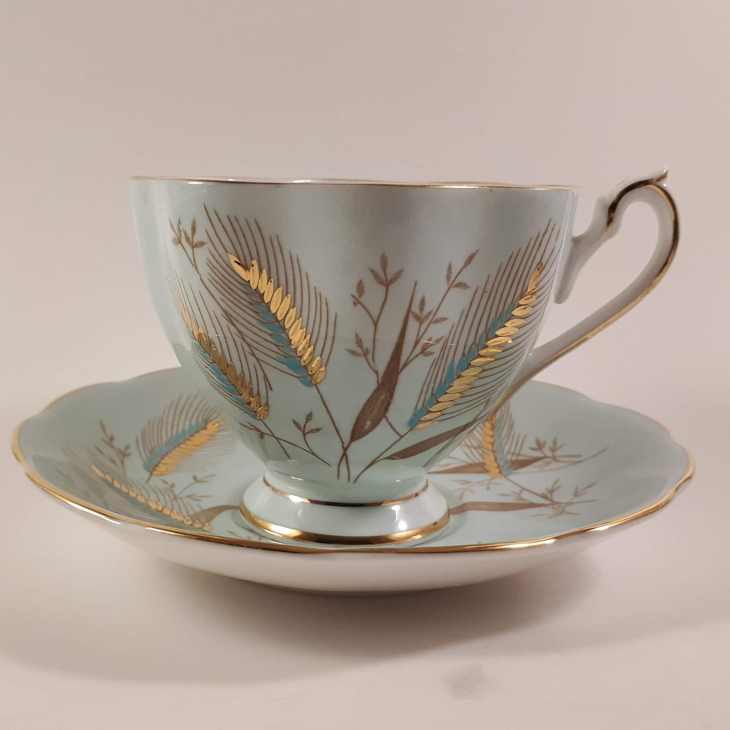 Stunning Queen Anne bone china turquoise shaded with heavy gold designs teacup