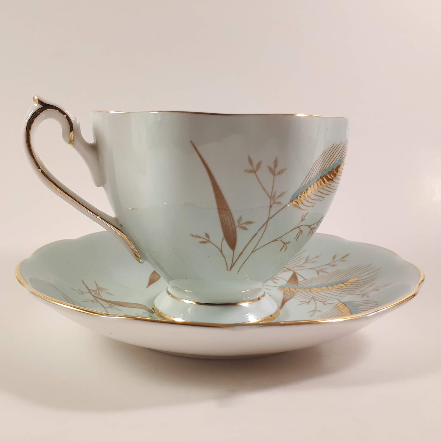 Stunning Queen Anne bone china turquoise shaded with heavy gold designs teacup